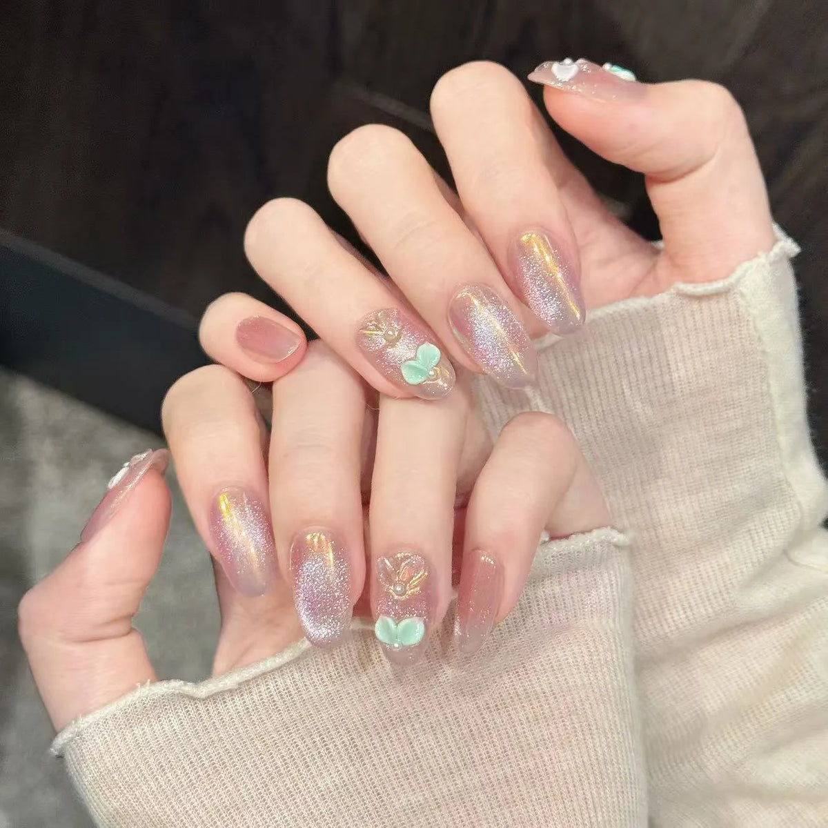 Aurora Pearl oval nails angled view showing iridescent finish and dreamy romantic design ✨