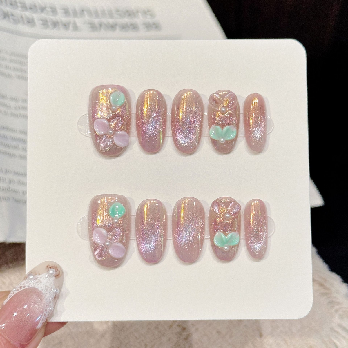 Aurora Pearl short oval press-on nails with pink aurora 3D flower pearl dreamy design on hand - lifestyle shot 💗✨