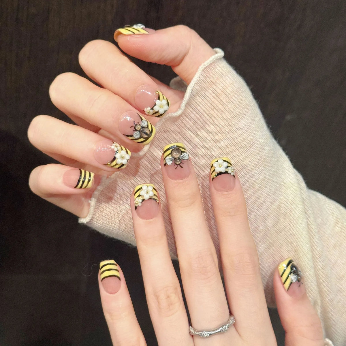 Bee Garden square nails angled view showing yellow black stripes and 3D floral bee art 🌼