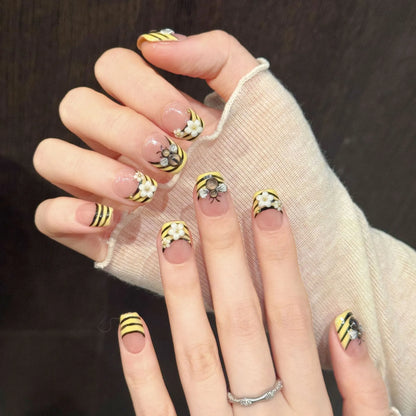 Bee Garden square nails angled view showing yellow black stripes and 3D floral bee art 🌼