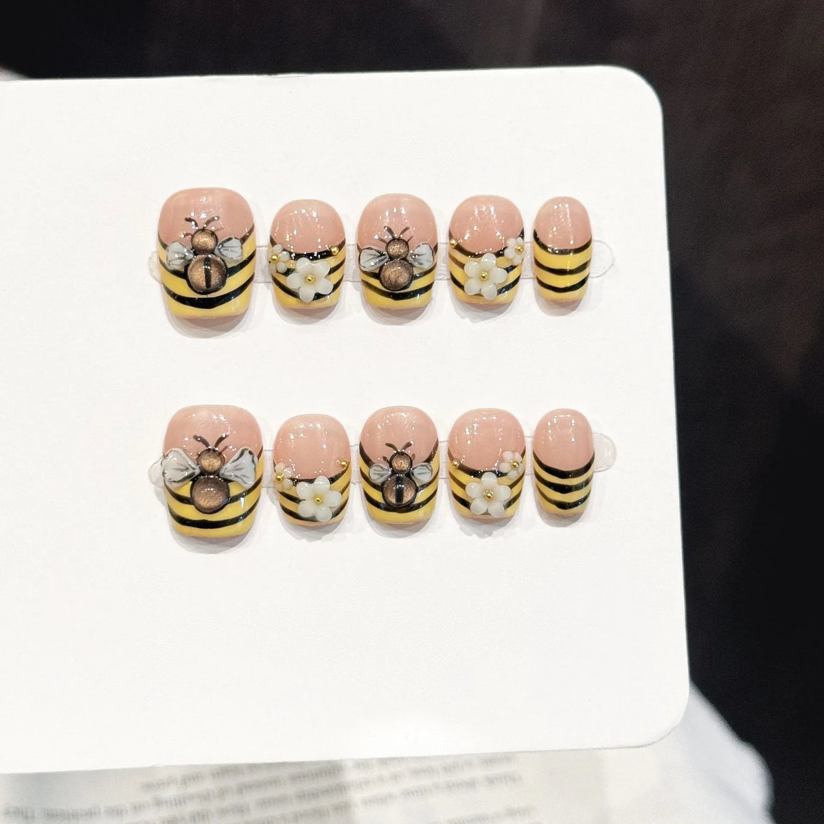Bee Garden short square press-on nails with 3D bee and white flower playful design on hand - lifestyle shot 🐝🌼