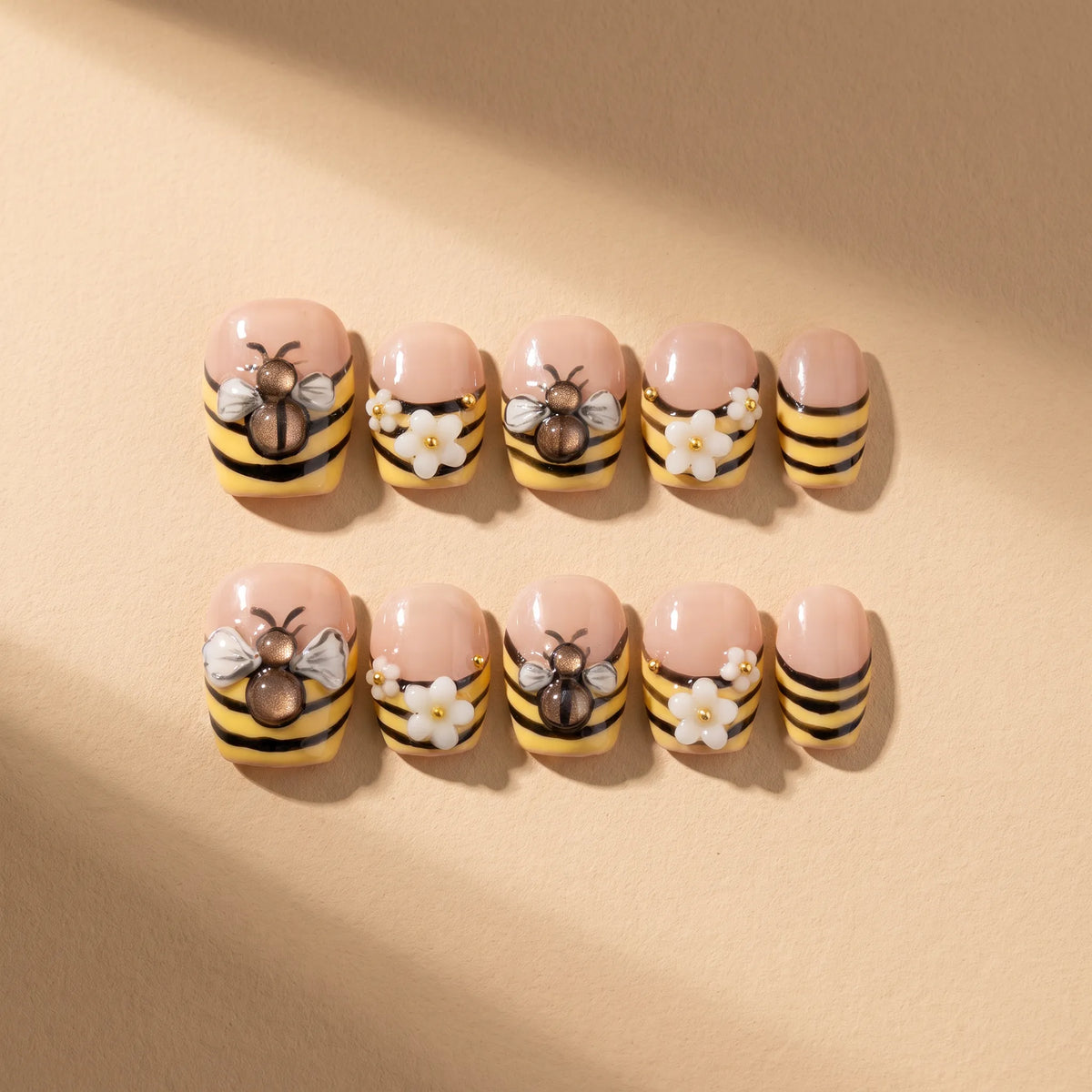 Bee Garden 10-piece handmade press-on nail set with 3D bee and flower designs - product flat lay 🐝