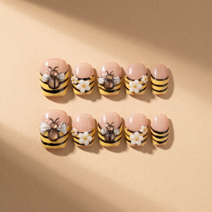 Bee Garden 10-piece handmade press-on nail set with 3D bee and flower designs - product flat lay 🐝