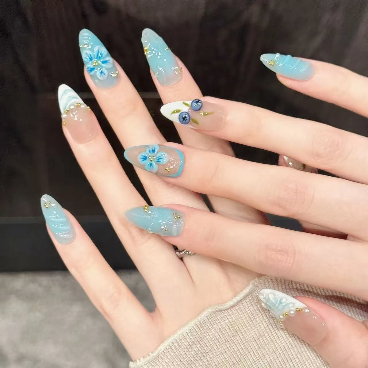 Close-up detail of Blue Berry hand-painted blueberries, ice blue gradient, and carved floral details 🌸✨
