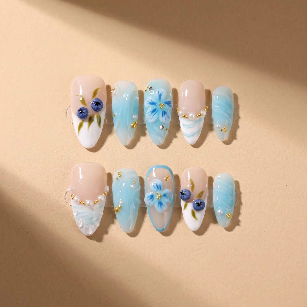 Blue Berry 10-piece handmade press-on nail set with blueberry and floral designs - product flat lay 🫐