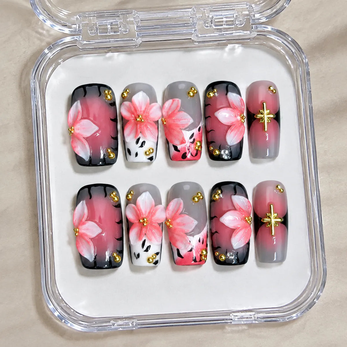 Blush Noir Sakura NM-C262 handmade Medium Coffin nail set arranged in a clear presentation case