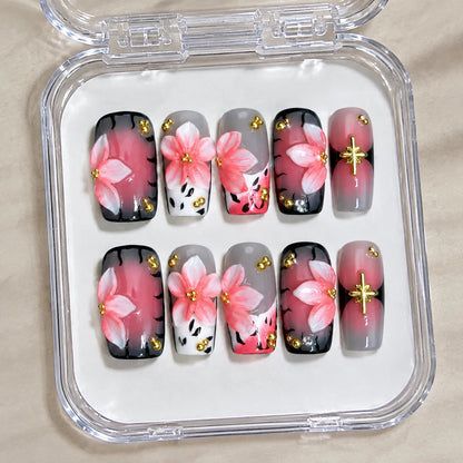 Blush Noir Sakura NM-C262 handmade Medium Coffin nail set arranged in a clear presentation case