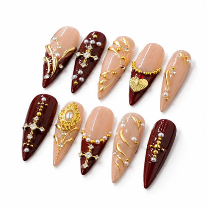 Detailed view of NM-Z220 Long Stiletto nails with a sacred heart gold filigree and botanical lines