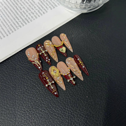 Lifestyle flat lay of burgundy blush and gold NM-Z220 Long Stiletto press-on nails