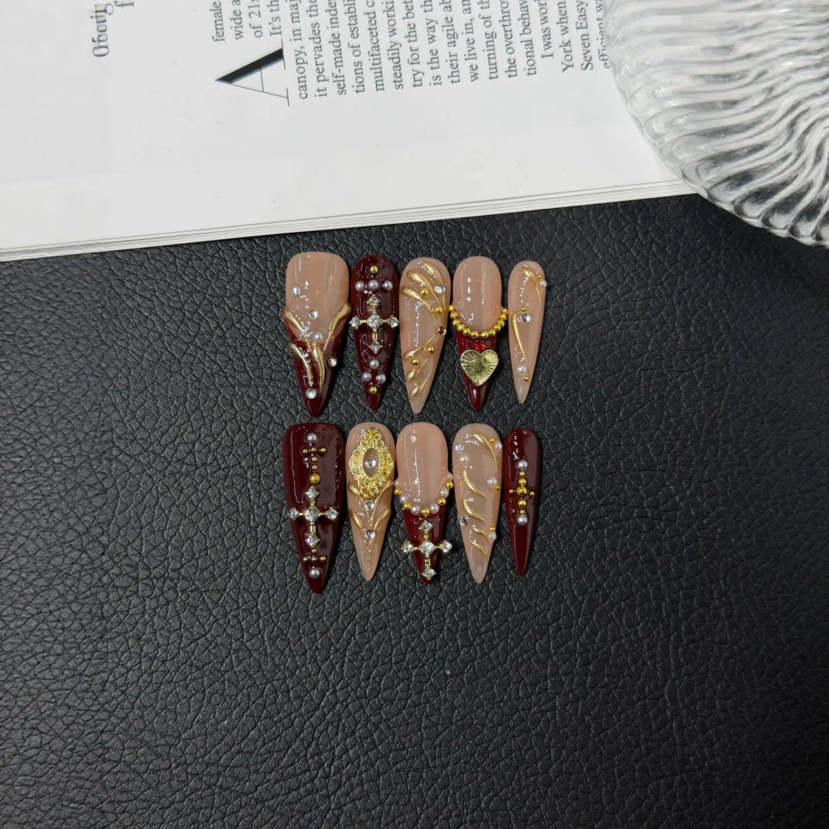 Additional lifestyle view of Burgundy Reliquary cross pearl and gold Long Stiletto nails