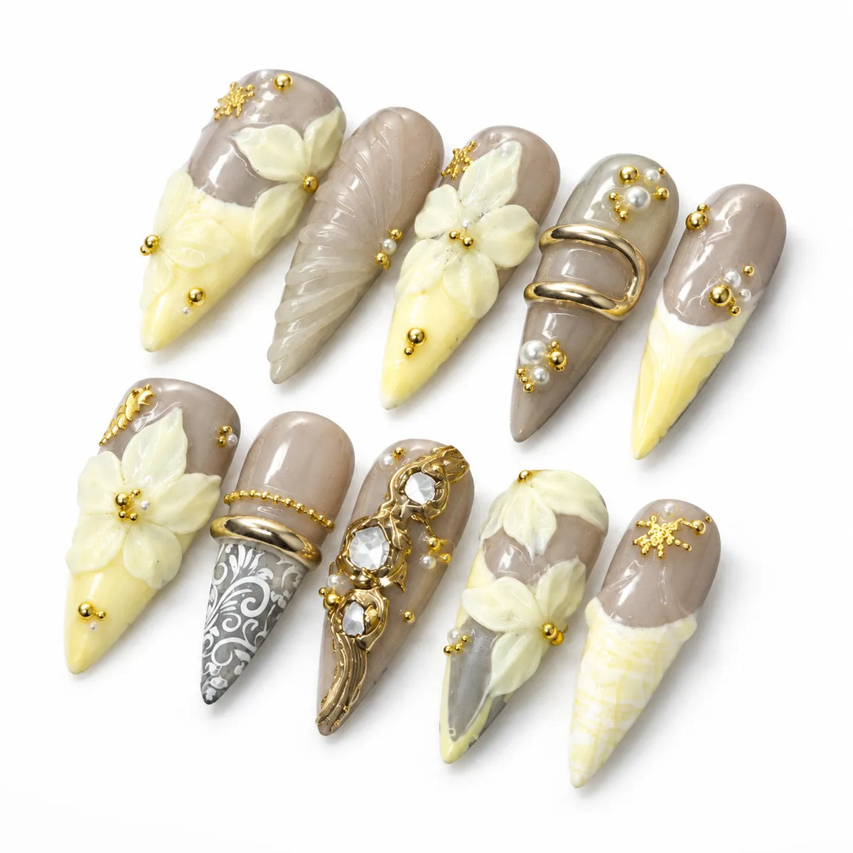 Angled view of taupe nude and butter-yellow Long Stiletto nails with pearls and sculpted florals