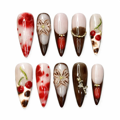 Cherry Mocha Bloom NM-C017 Long Stiletto press-on nail set with red cherries, brown French tips, flowers, and gold accents