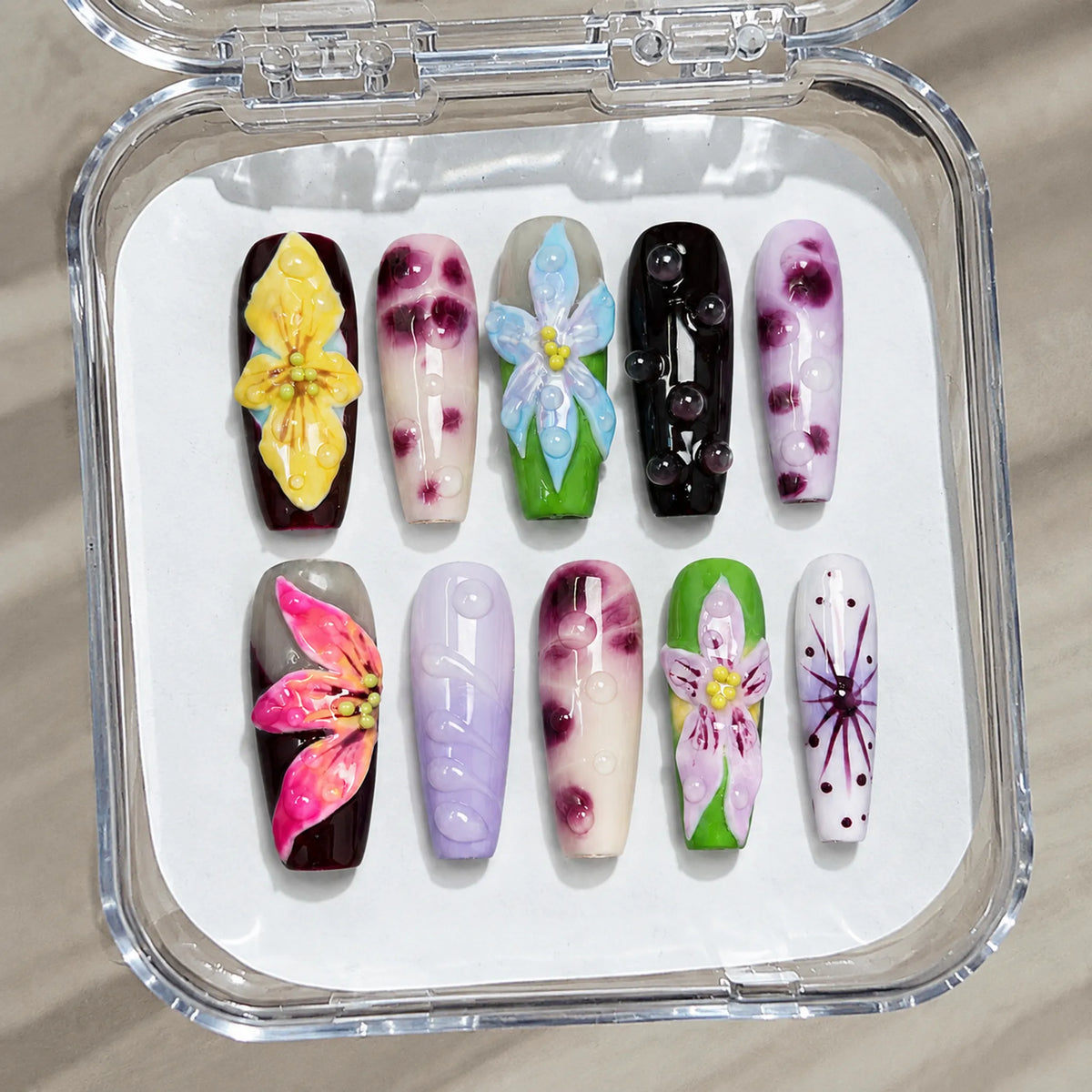 Chromatic Orchid Dew handmade Medium Coffin nail set arranged in a clear presentation case