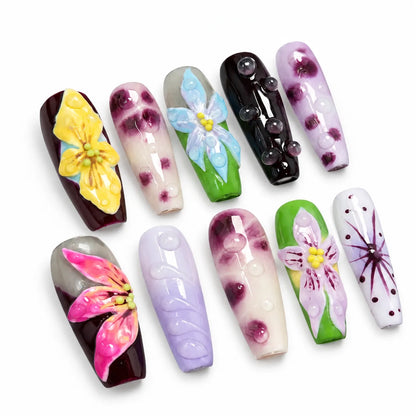 Detailed view of NM-A002 Medium Coffin nails with pink yellow blue and lavender floral art