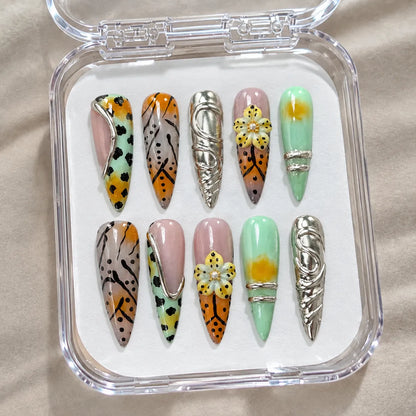 Chrome Wildflower Fusion handmade Long Stiletto nail set arranged in a clear presentation case