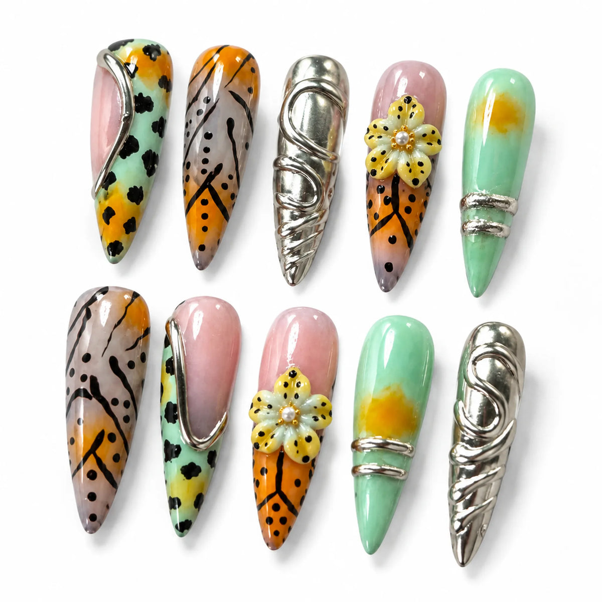 Detailed view of NM-Z189 Long Stiletto nails with sculpted flower silver frames and chrome relief