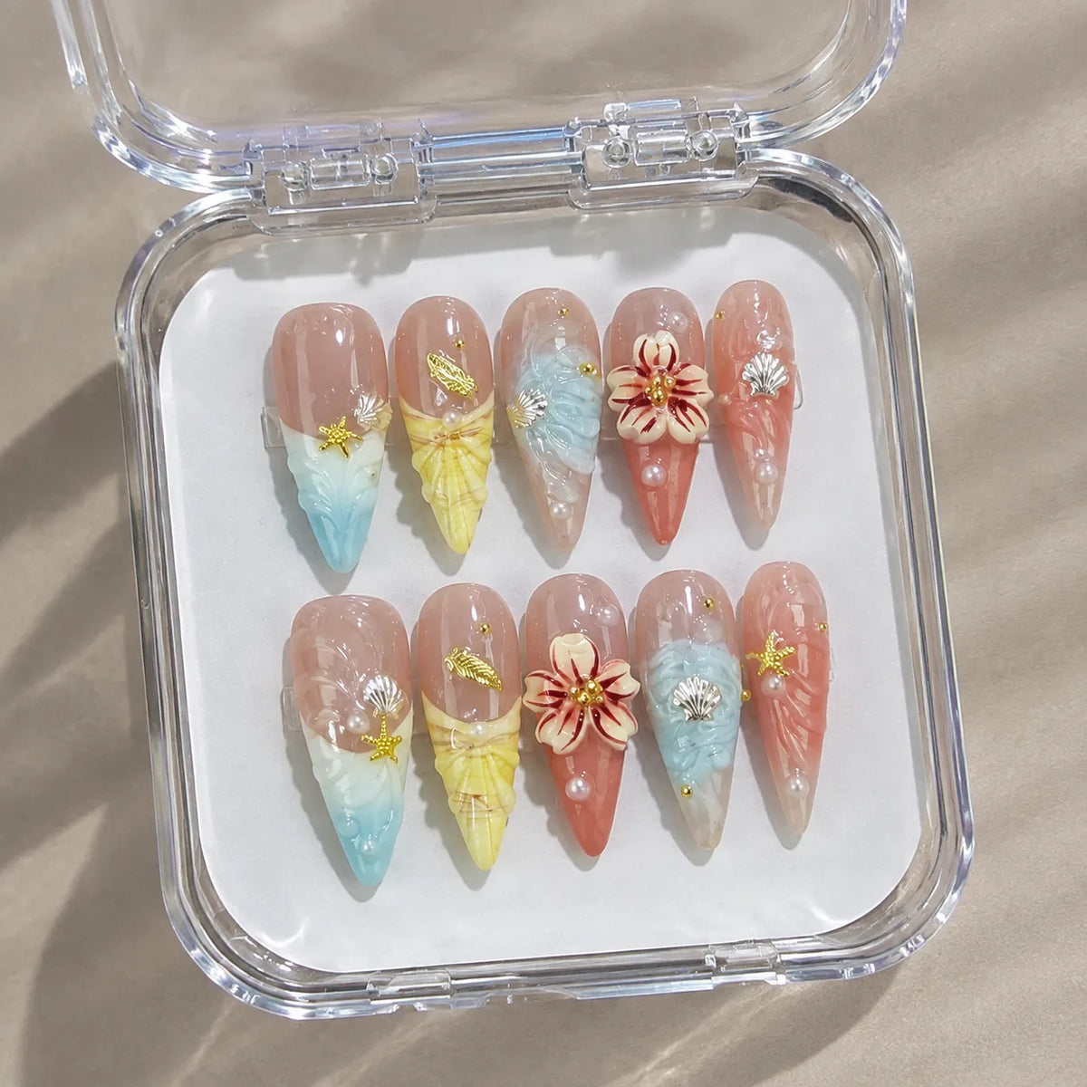 Coastal Bloom NM-C106 nail set in a clear case under natural light