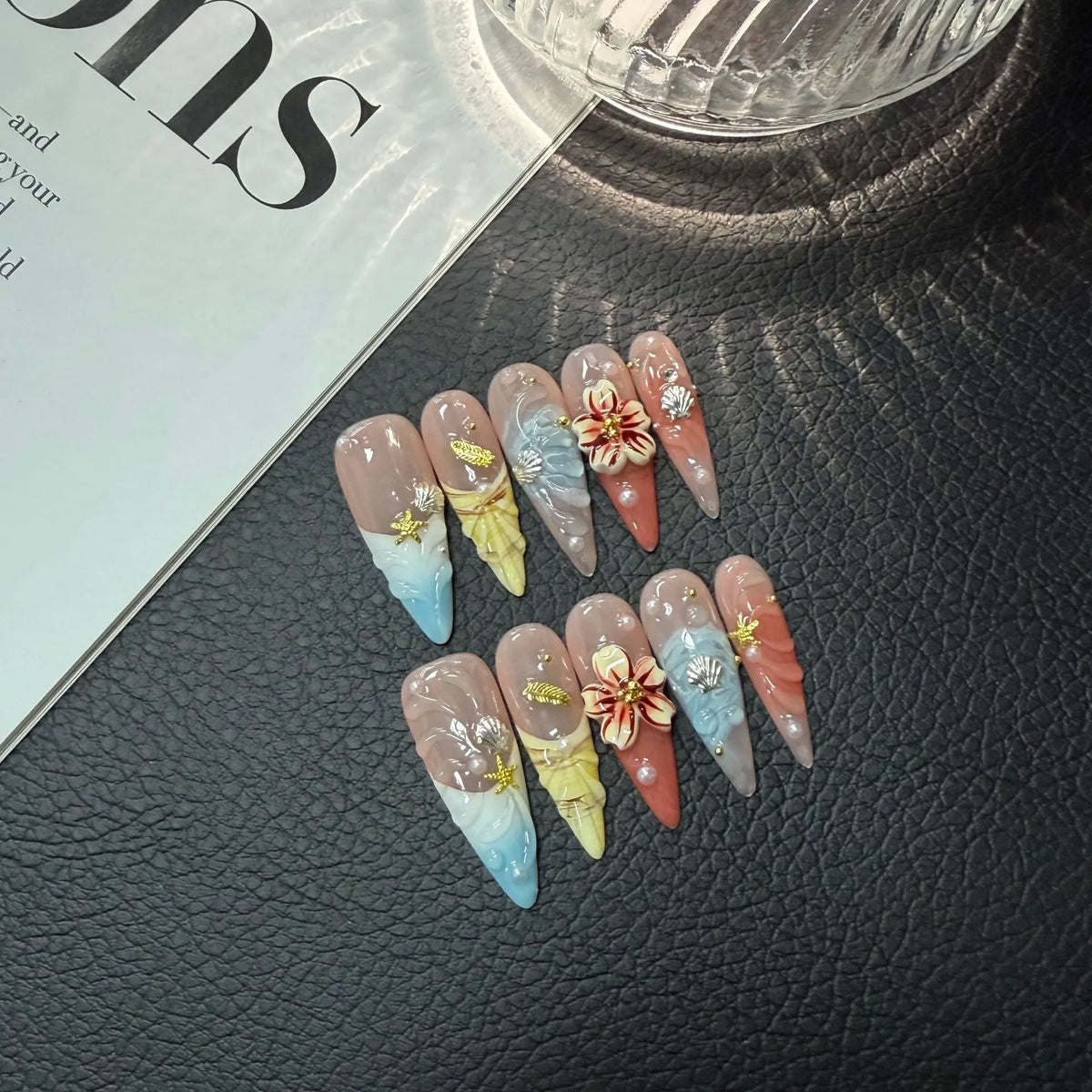 Closer lifestyle view of Coastal Bloom Long Stiletto nails with dimensional seashell and floral art