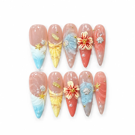 Coastal Bloom NM-C106 Long Stiletto press-on nail set with colorful shell textures, flower, starfish, and pearls