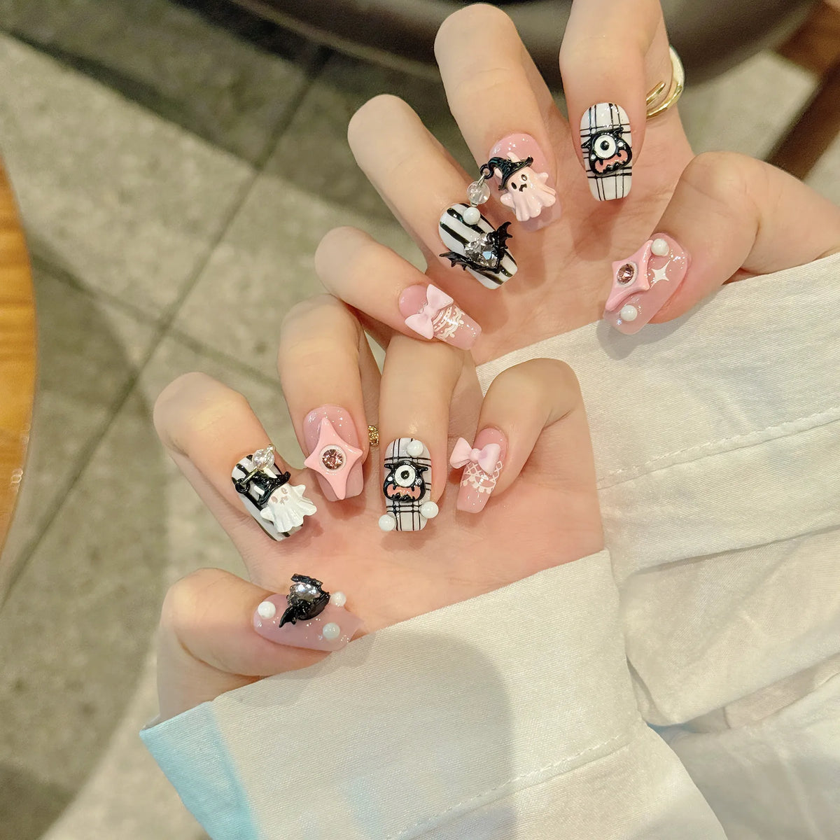 Devil Heart cute Halloween nails shown on hands with raised eye, ghost, bat and heart details