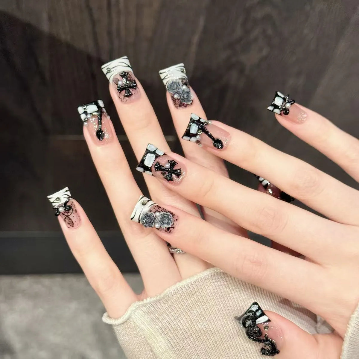 Close-up detail of Dragon Rose black dragon imagery, dark roses, cross symbols, and metallic accents ✝️🖤