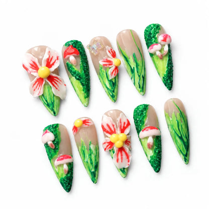 Angled view of nude and green Long Stiletto nails with sculpted flowers mushrooms and butterfly accent