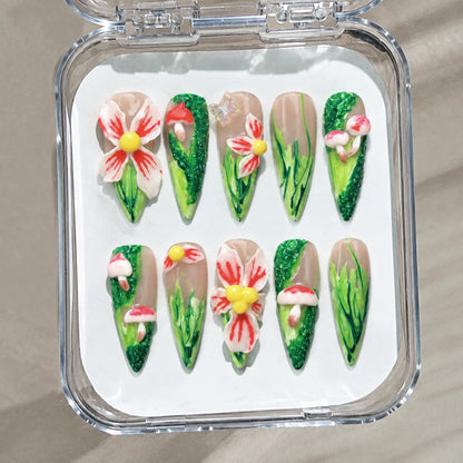Enchanted Mushroom Meadow handmade Long Stiletto nail set arranged in a clear presentation case