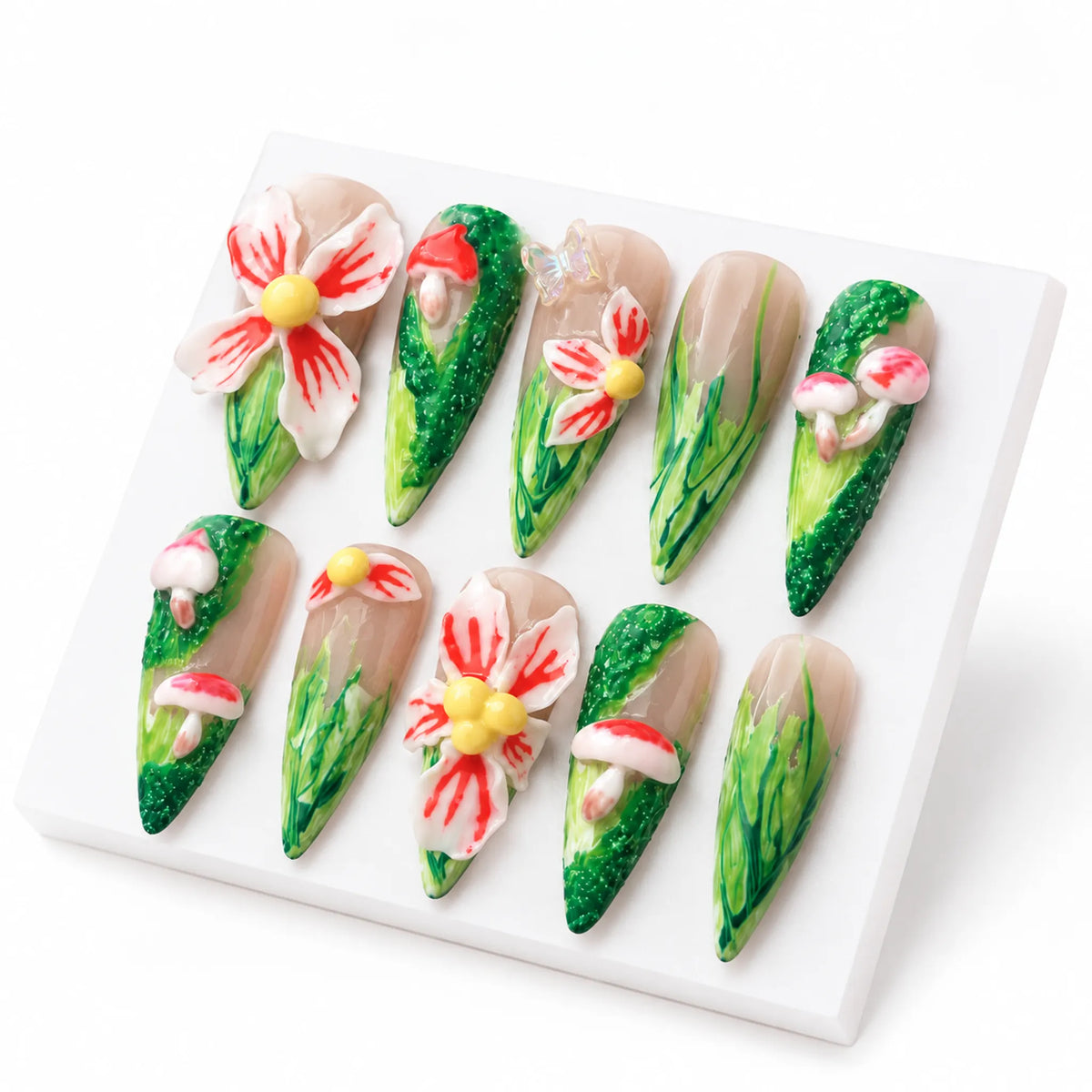 Detailed presentation of NM-A027 Long Stiletto nails showing textured moss and hand-painted meadow grass