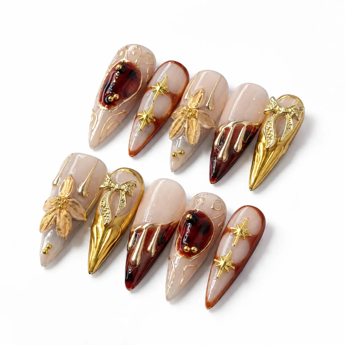 Detail view of Gilded Court Fleur Baroque nails showing raised scrollwork starbursts and gold ornaments