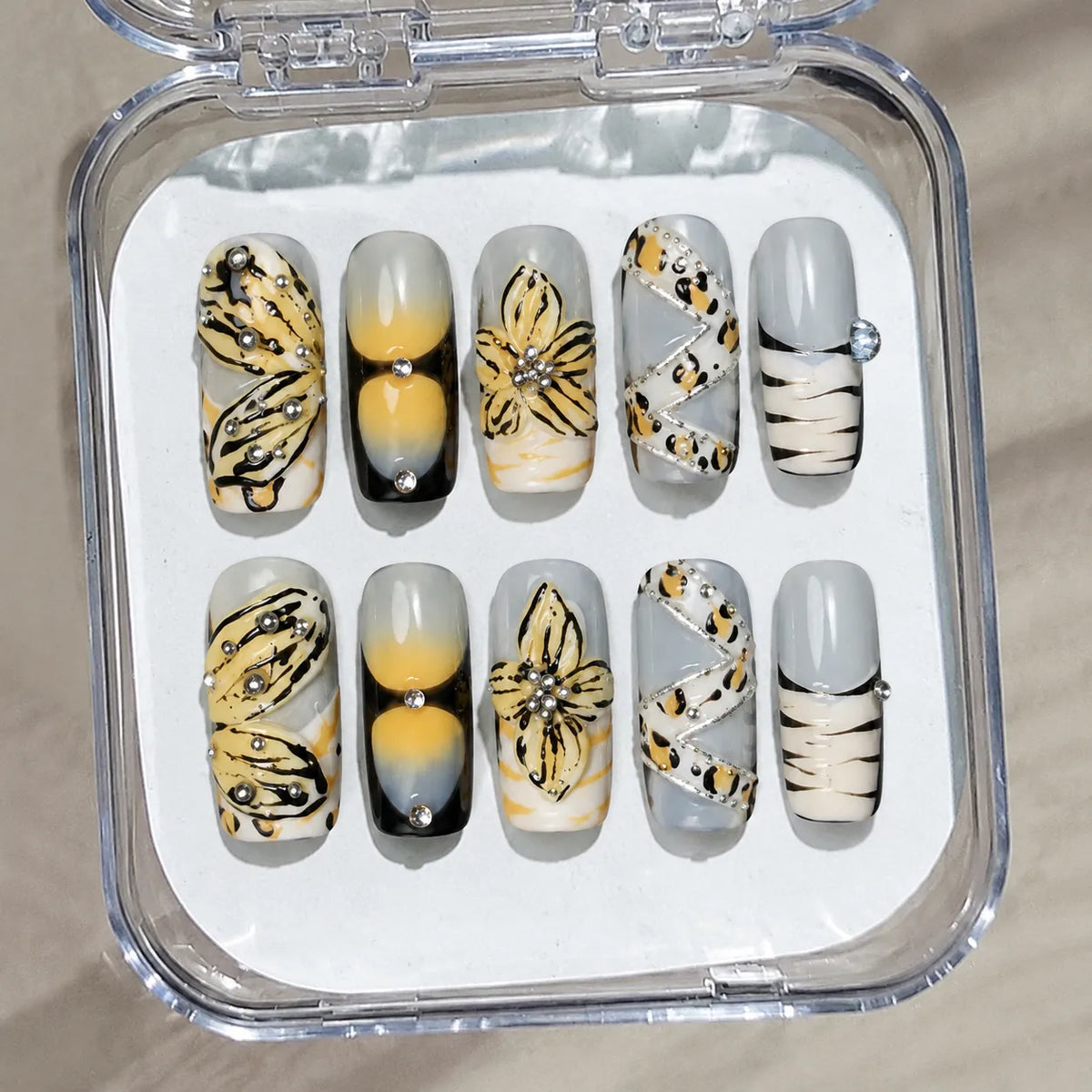 Golden Butterfly Reverie handmade Medium Coffin nail set arranged in a clear presentation case