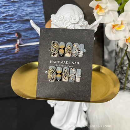 Lifestyle display of NM-A030 Medium Coffin nails with butterfly leopard and yellow ombre designs