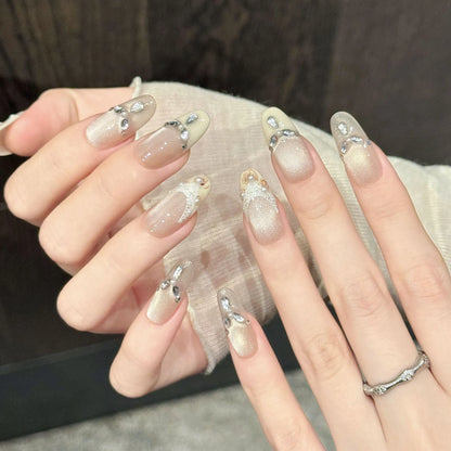 Golden Elegance oval nails angled view showing nude tones, magnetic shimmer, and romantic lace art 💛