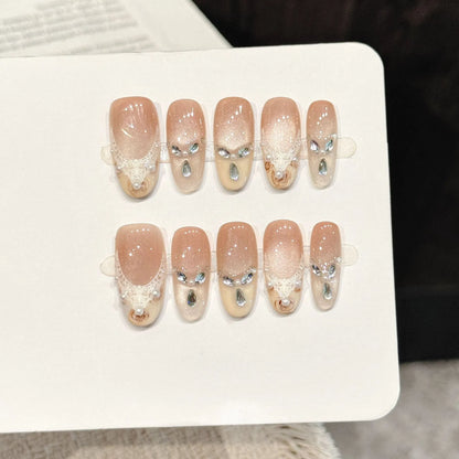 Golden Elegance long oval press-on nails with nude cat eye lace pearl soft luxe design on hand - lifestyle shot 💛✨