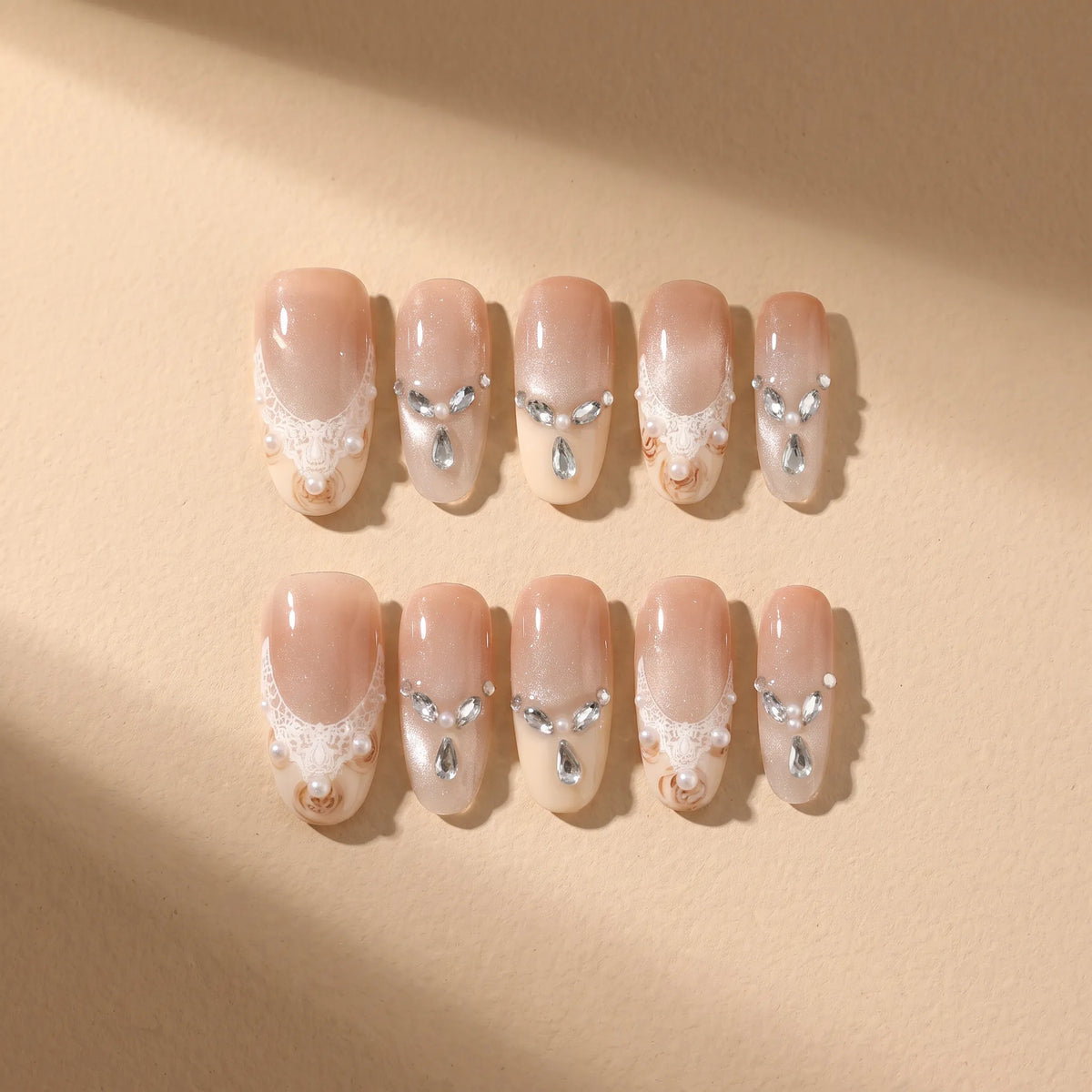 Golden Elegance 10-piece handmade press-on nail set with lace and pearl designs - product flat lay 💛