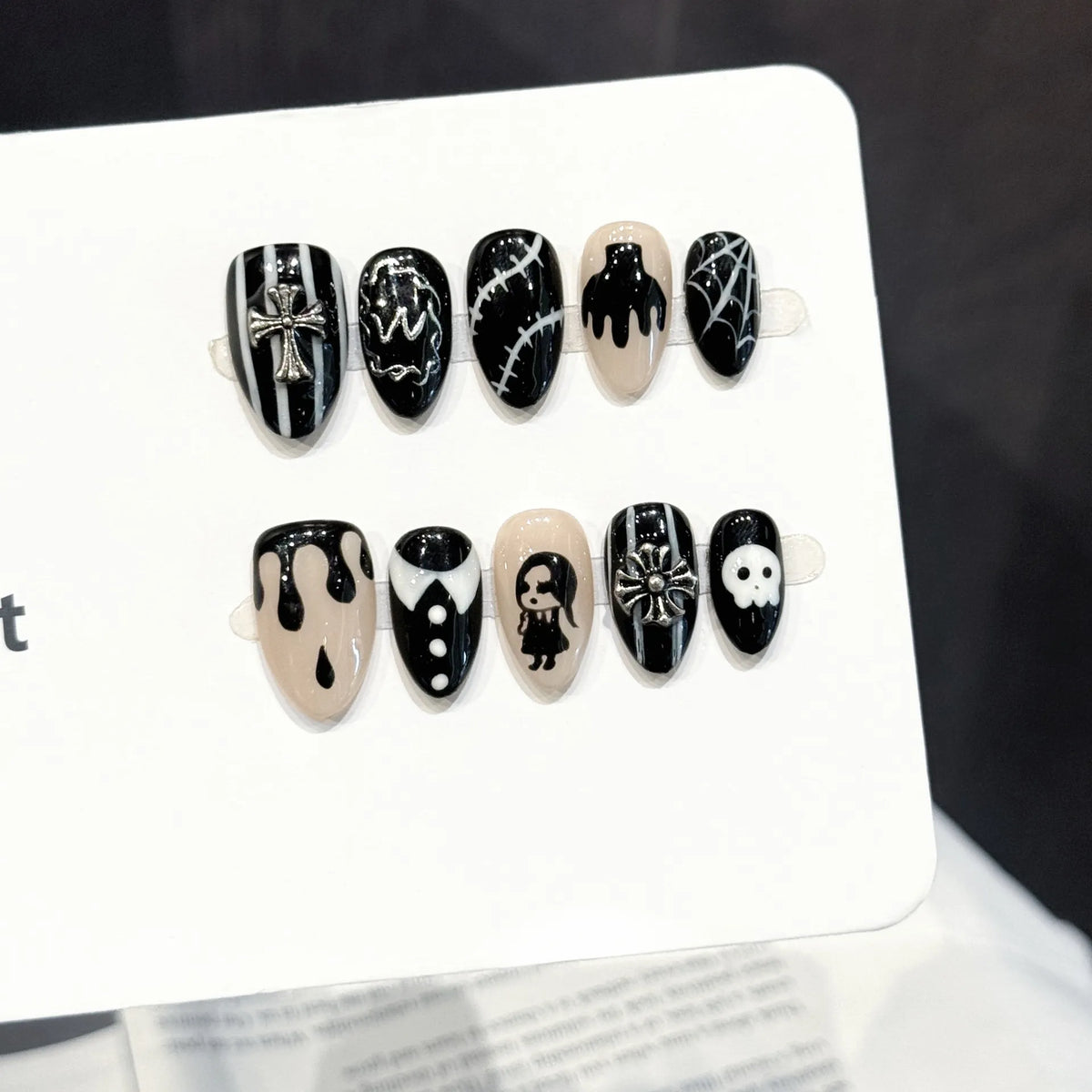 Gothic Shadow long stiletto press-on nails with 3D cross, skull, and doll gothic design on hand - lifestyle shot 💀⛓️