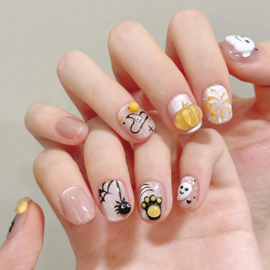 Halloween Ghost Kitty short oval press-on nails worn on both hands showing pumpkin, spider and ghost details
