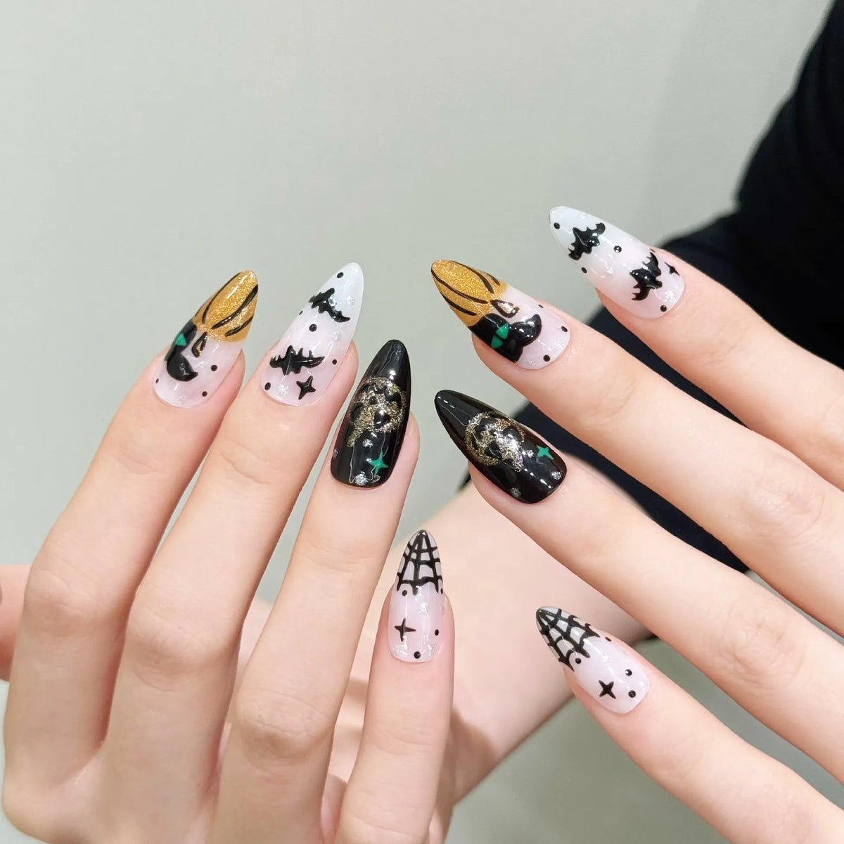 Halloween pumpkin devil medium almond press-on nails 3029 shown in a lifestyle hand view