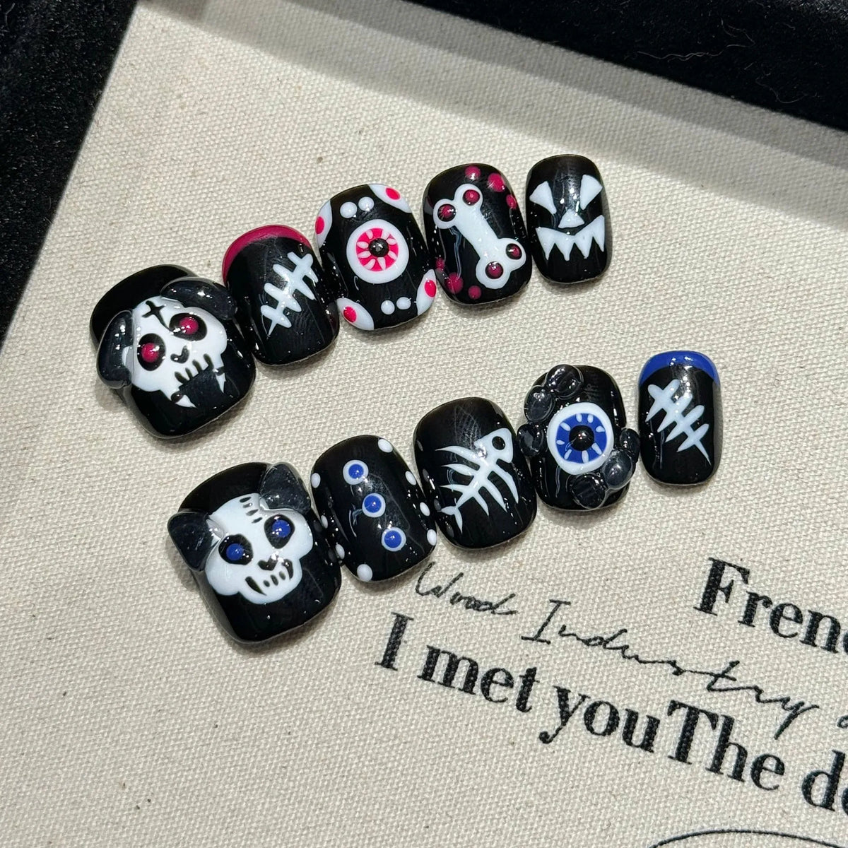 Halloween Pumpkin Skull short oval press-on nails with orange pumpkin and skull design on hand - lifestyle shot 🎃💀
