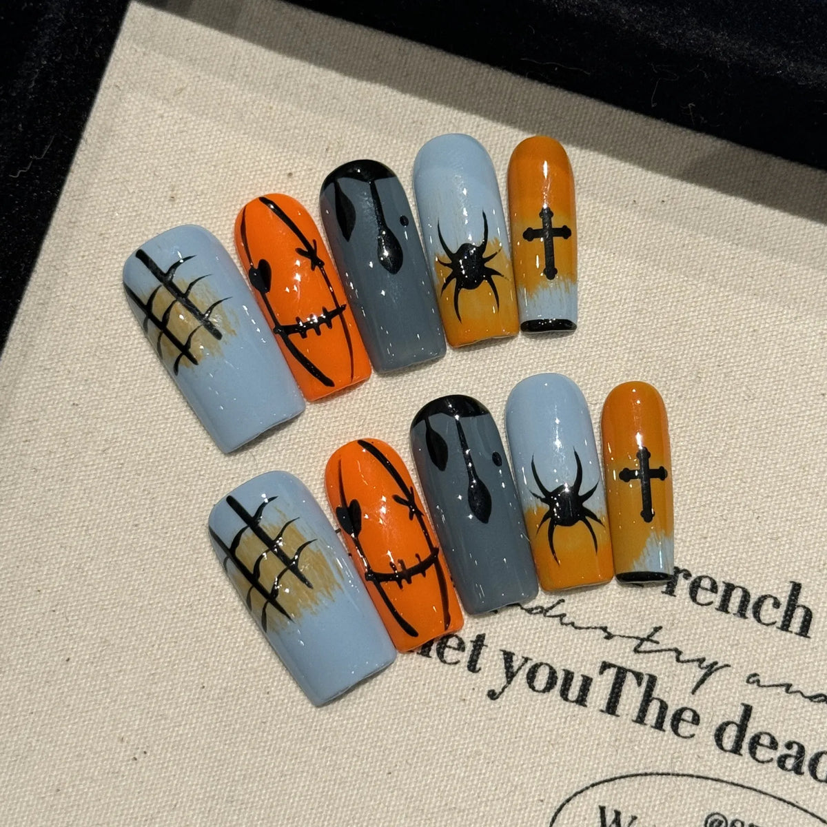 Halloween Stitch Spider long square press-on nail set with orange gray gradients, webs and black spiders