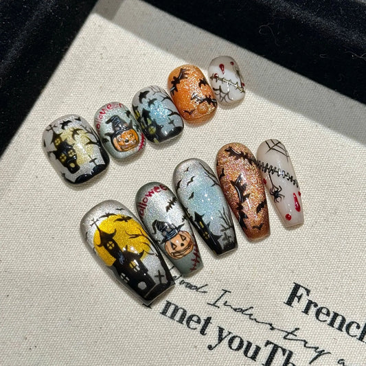 Haunted Moon Halloween press-on nails in Short Oval and Medium Coffin shapes with pumpkins, bats, and haunted houses