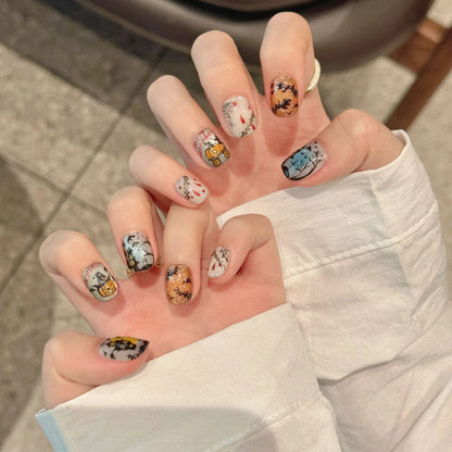 Haunted Moon 2373 Short Oval Halloween nails shown in a hand lifestyle view with shimmering moonlit art