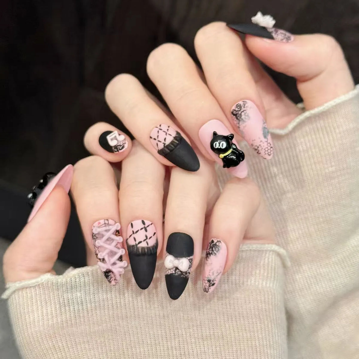 Honey Cat almond nails angled view showing black pink contrast and cute kawaii design 🐱