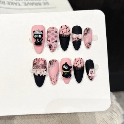 Honey Cat almond press-on nails with black pink cat music note lace bow sweet design on hand - lifestyle shot 🐱🎀