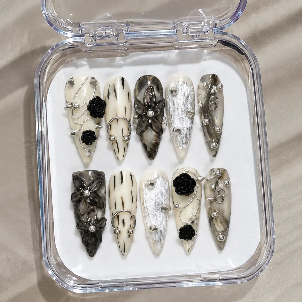 Inkthorn Noir NM-C171 handmade Long Stiletto nail set arranged in a clear presentation case