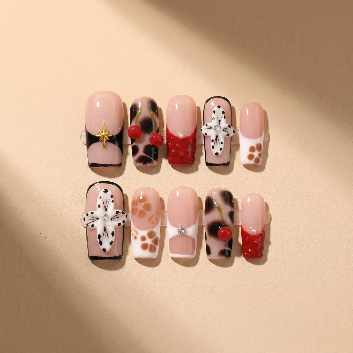 Leopard Cherry Blossom 10-piece handmade press-on nail set with leopard print and 3D cherry designs - product flat lay 🐆