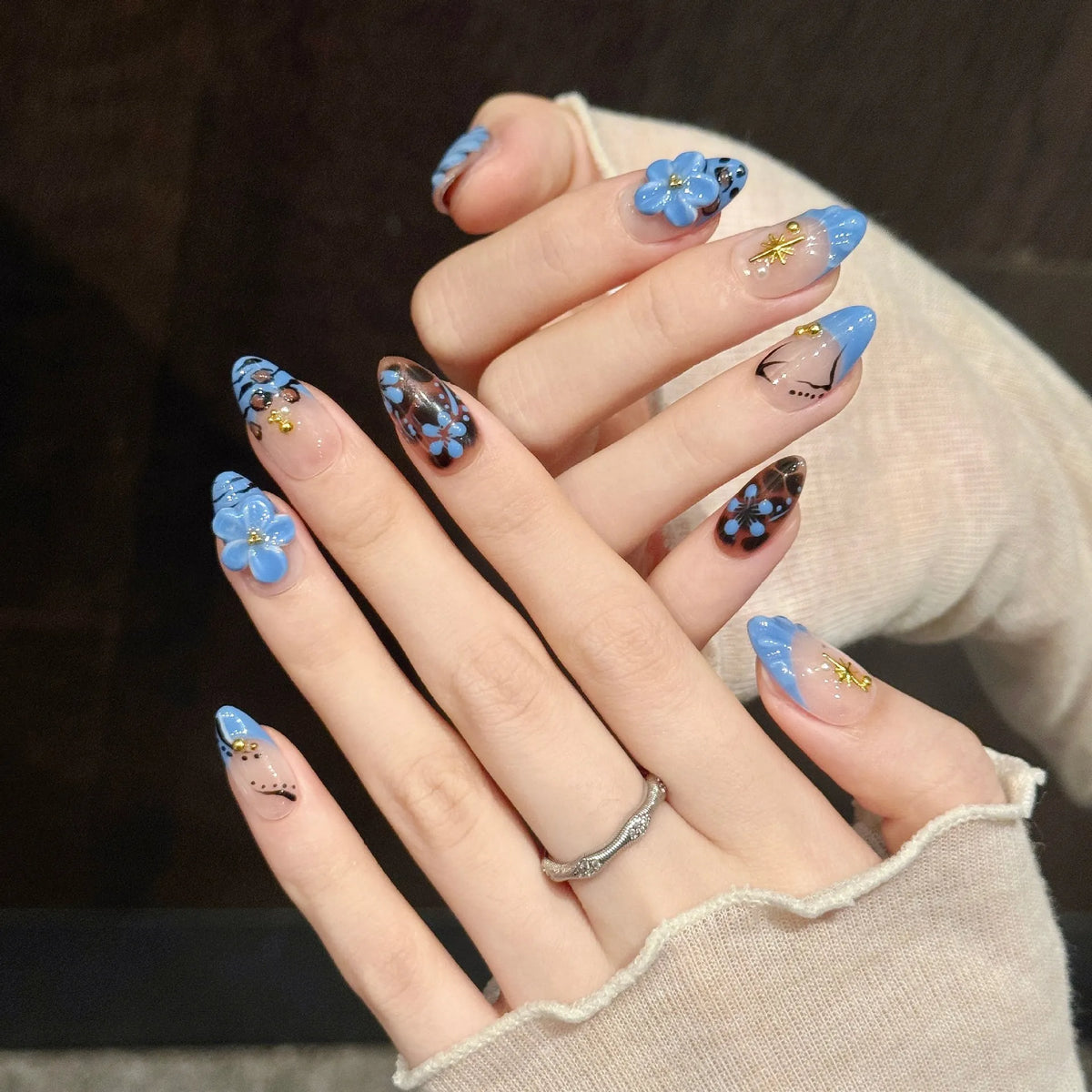 Close-up detail of Leopard Lagoon 3D blue flowers, tortoiseshell leopard print, and gold star charms