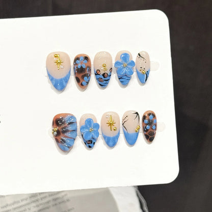 Leopard Lagoon short oval press-on nails with blue floral and leopard print design on hand - lifestyle shot