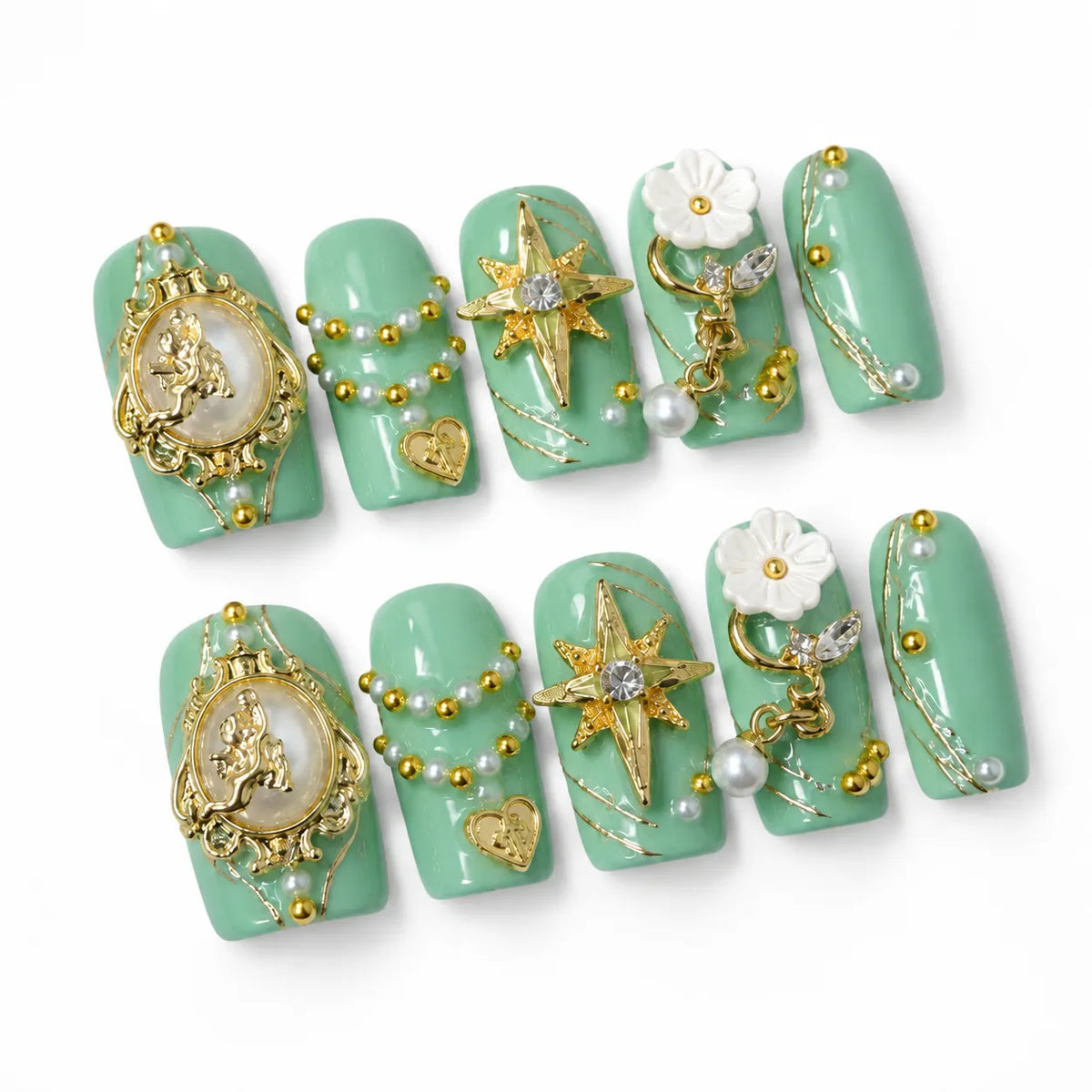 Angled view of mint-green Medium Coffin nails with gold angel cameos pearl garlands and crystal stars