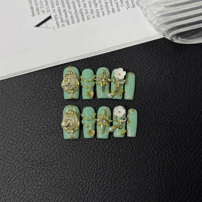 Lifestyle flat lay of mint green gold and pearl NM-C126 Medium Coffin press-on nails