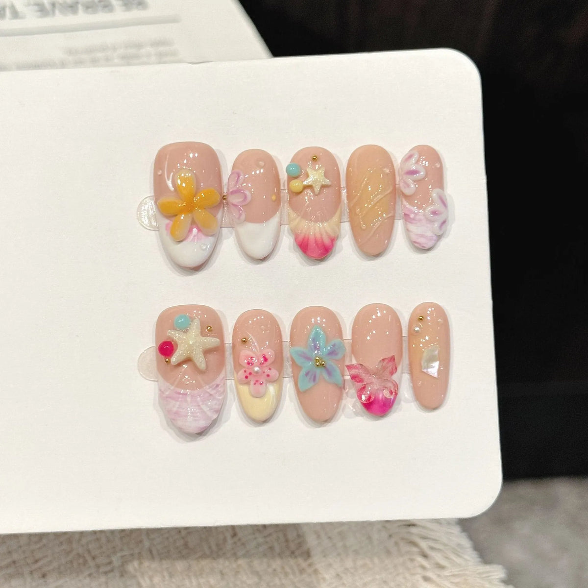 Ocean Shell short oval press-on nails with 3D seashell and starfish summer beach design on hand - lifestyle shot 🐚⭐